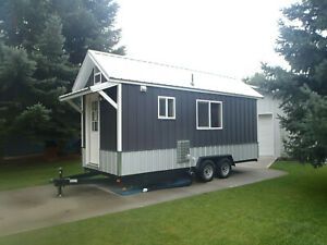 Brand new 20 x 7.5 wooden Tiny House on Wheels with RV hookups, weighing 7340lbs.